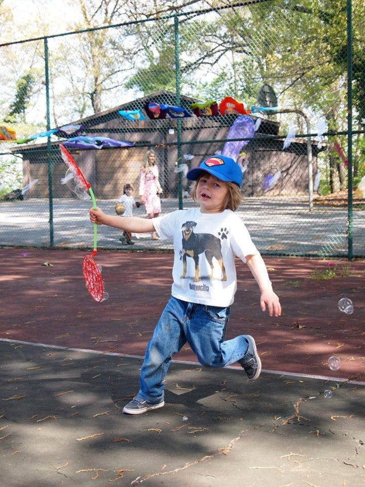 Child running with a bubble wand
