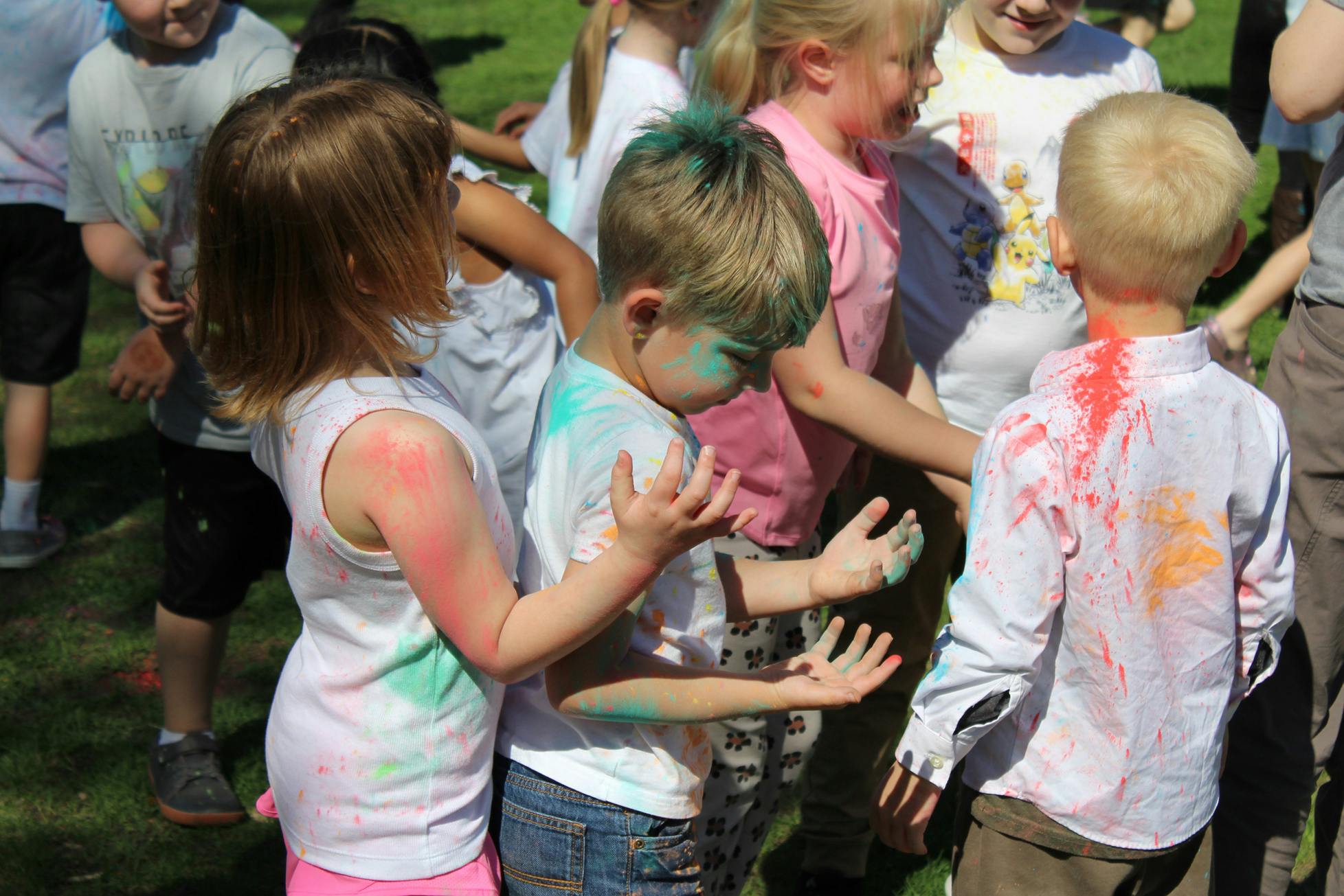 Children covered in colorful powder outdoors