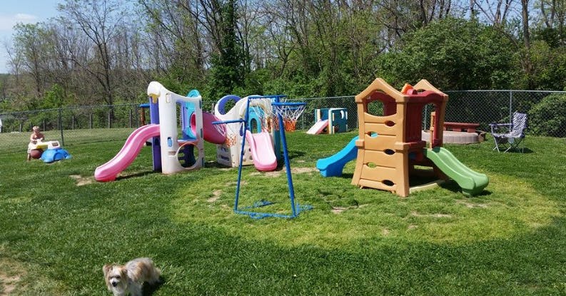 Outdoor playground with slides and play structures on grass