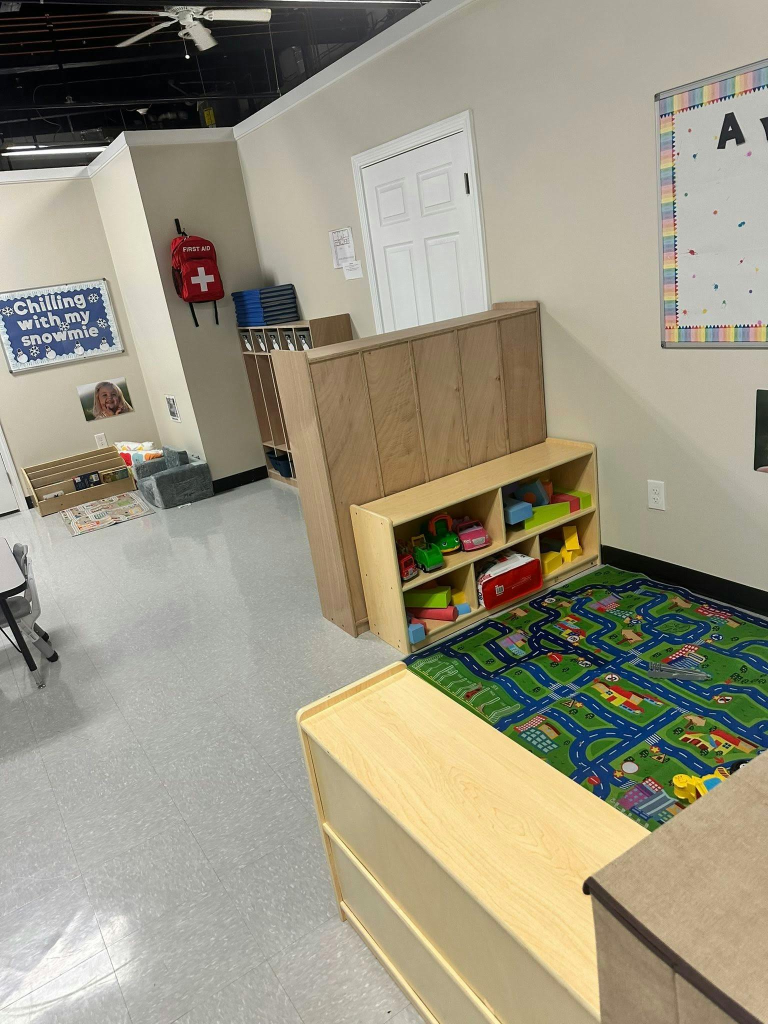 Classroom with children's toys, storage, and a road map playmat