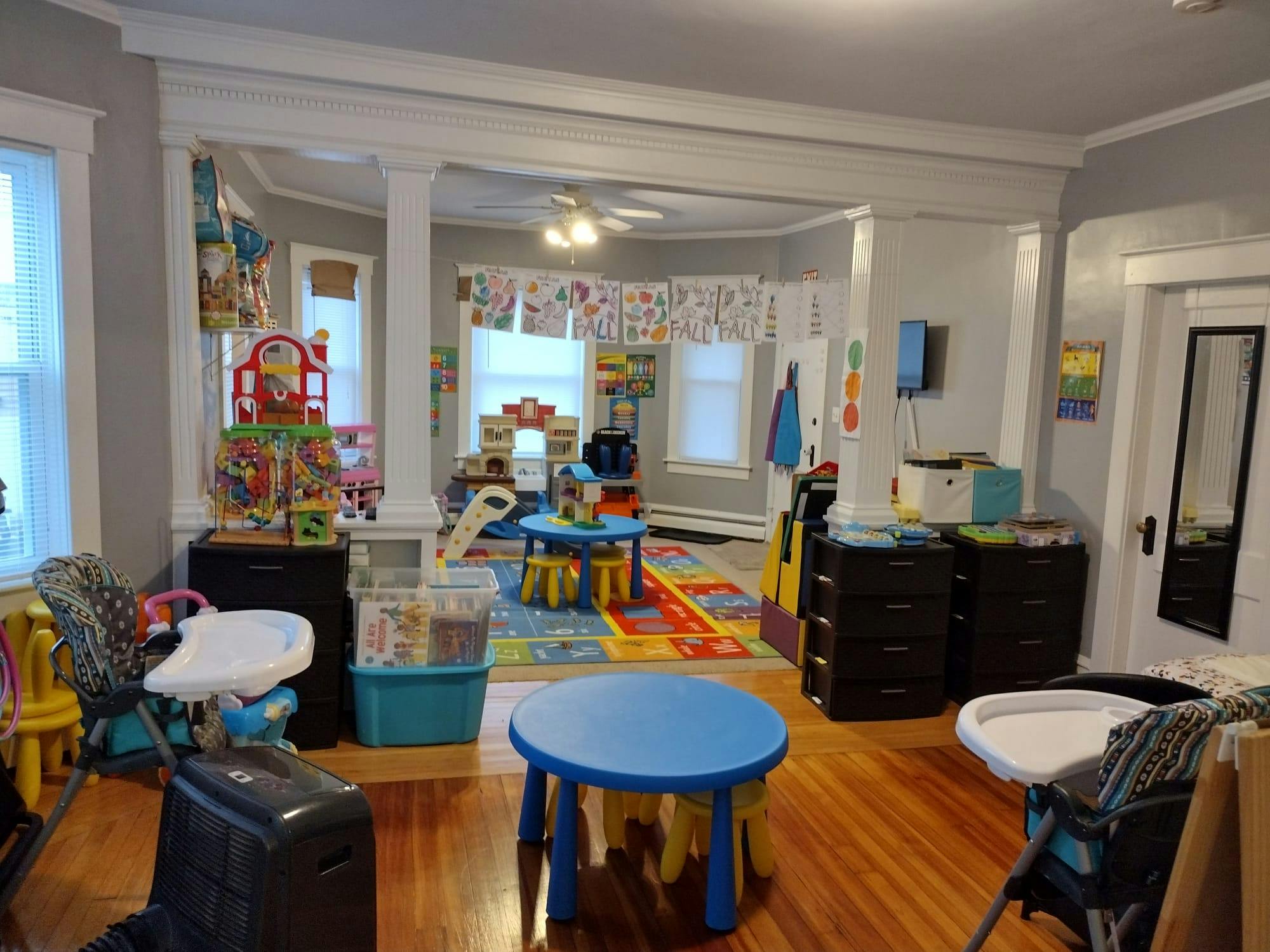 Playroom with small tables, chairs, and toys