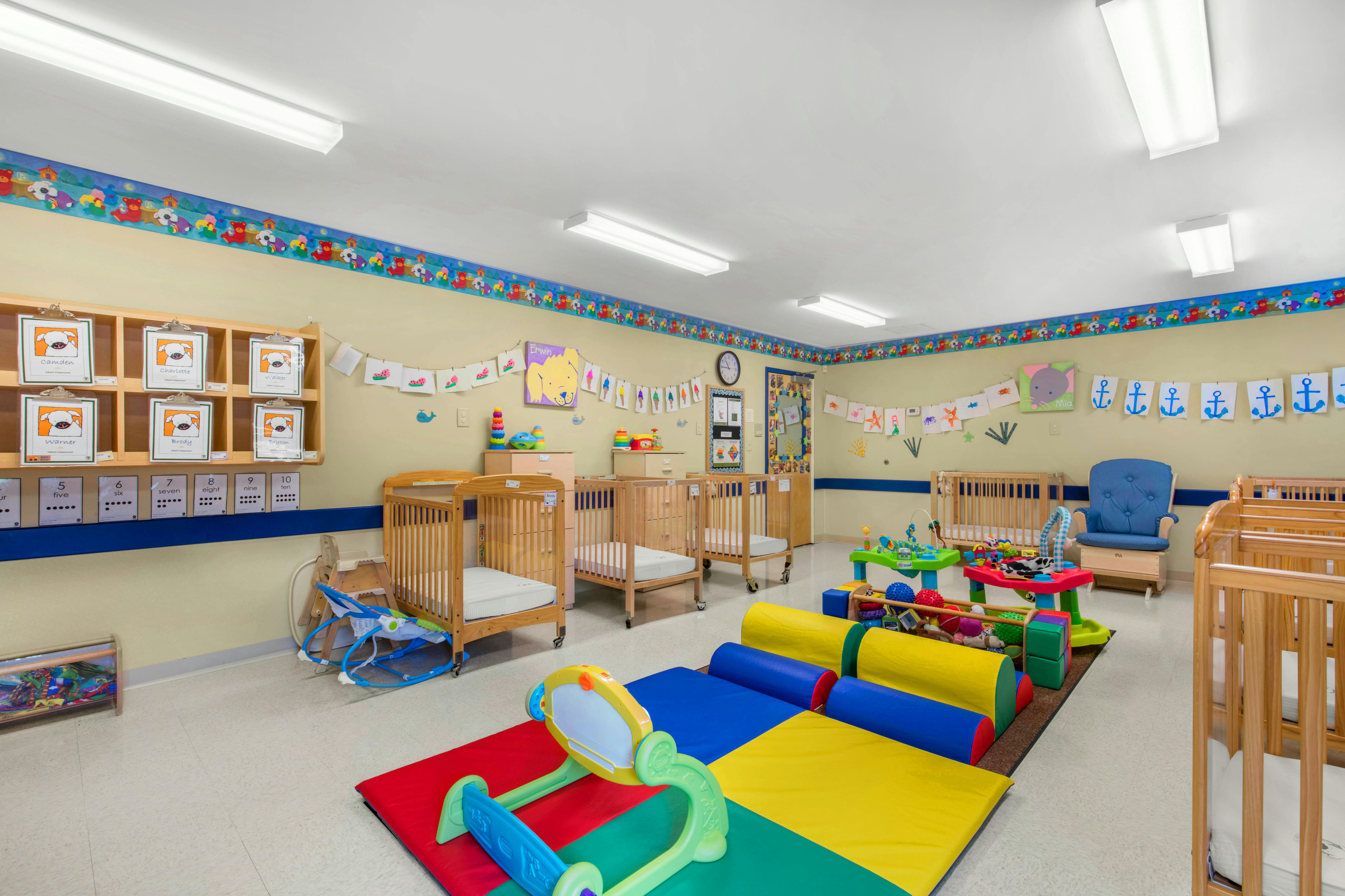 Cribs, play mats, and toys in an infant classroom