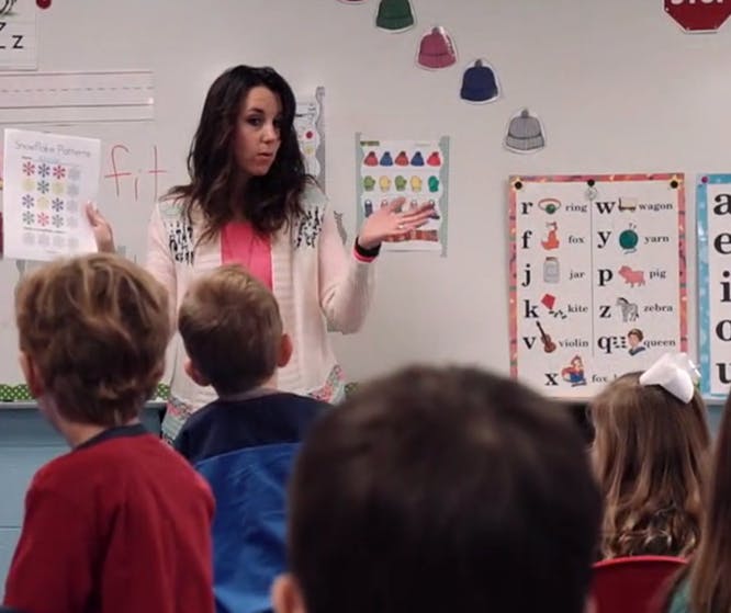 Person teaching children in a classroom