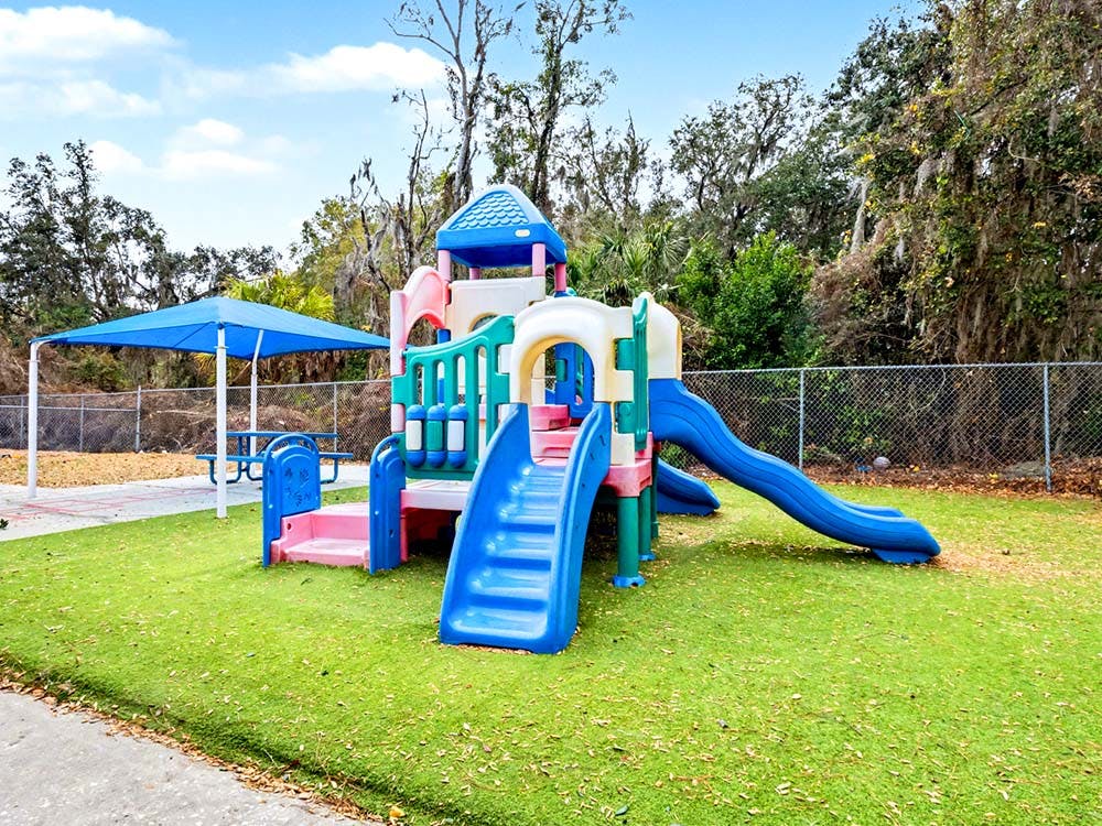 Colorful playground structure with slides on green turf
