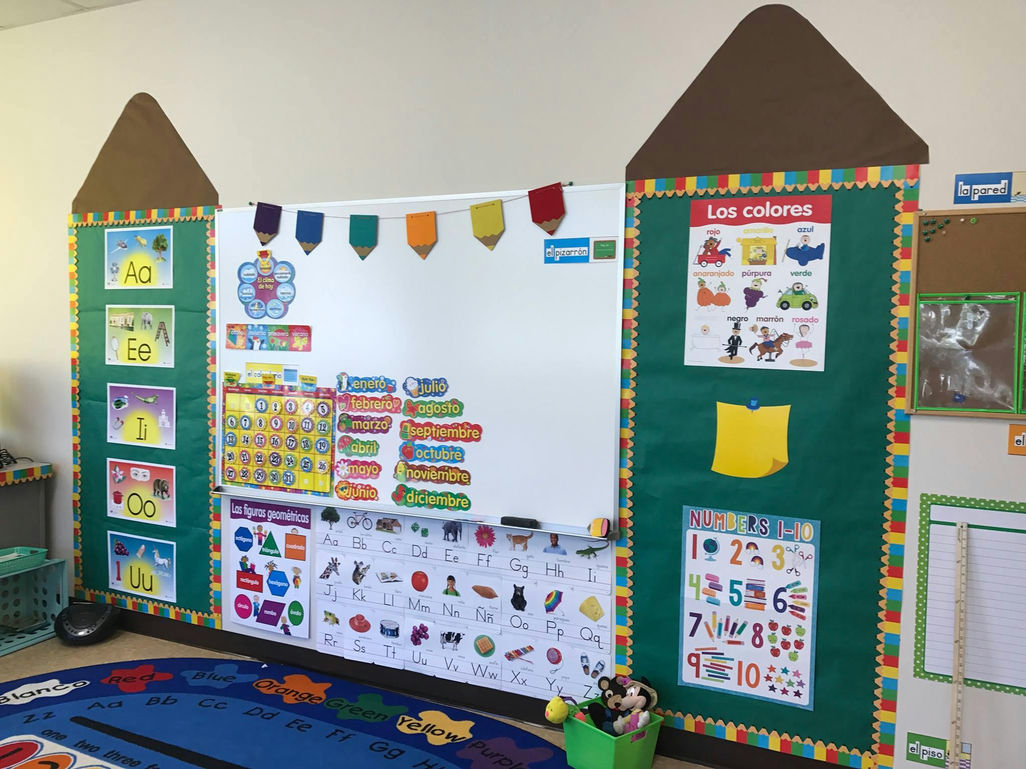Classroom whiteboard with colorful learning charts and decorations