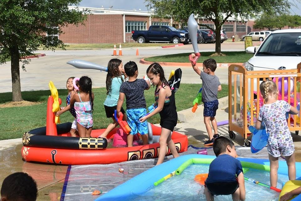 Children playing in inflatable pools outdoors