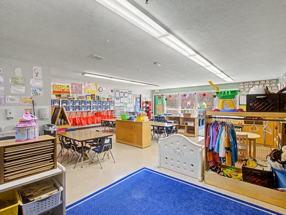 A colorful and well-equipped classroom with tables, chairs, and learning materials