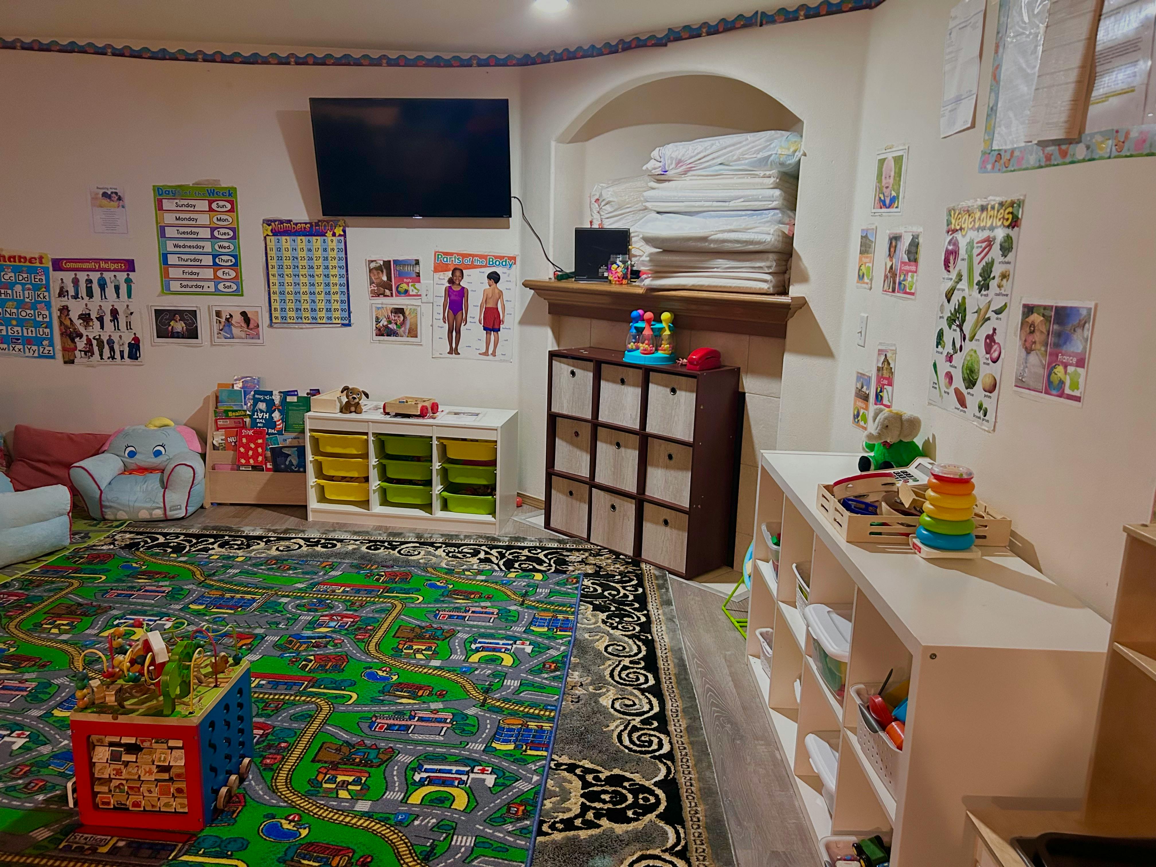 Playroom with a road map rug, toys, and storage shelves