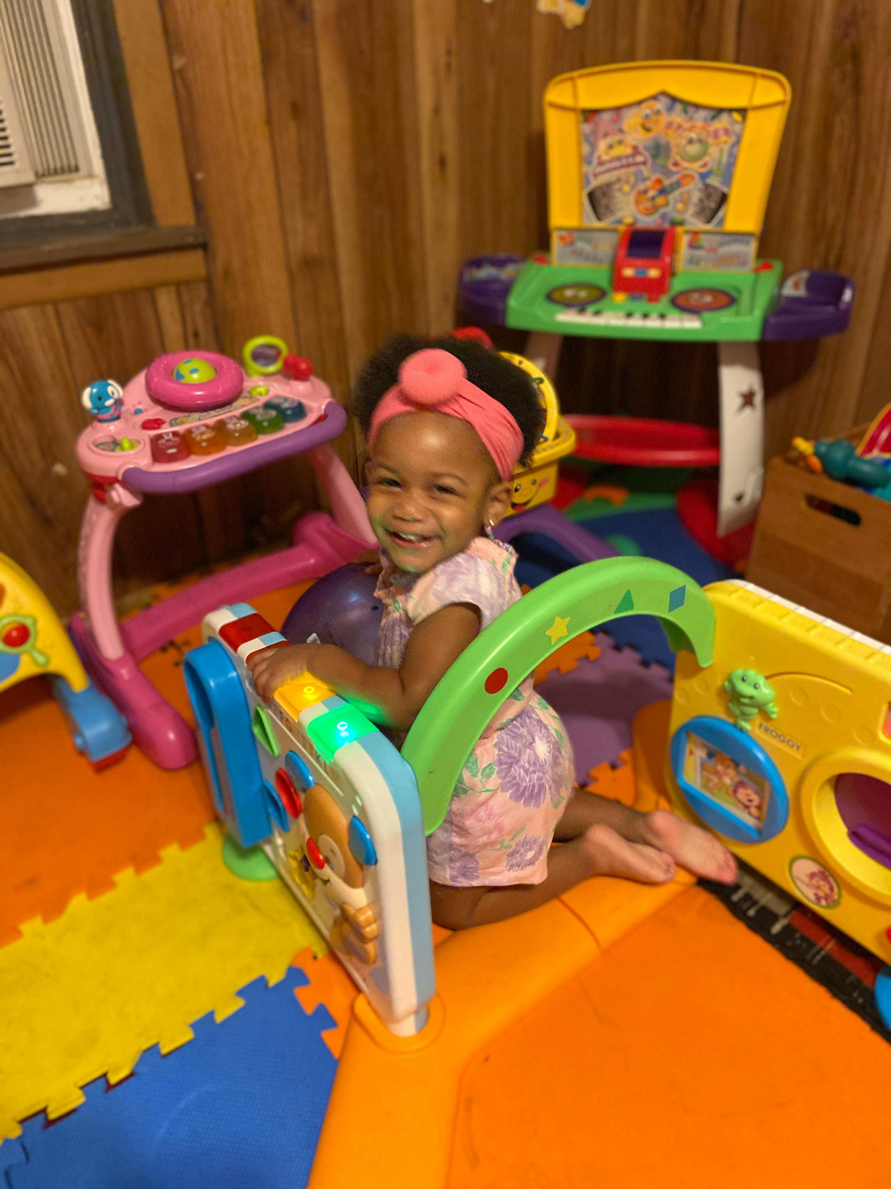 Child playing with colorful toys on a mat