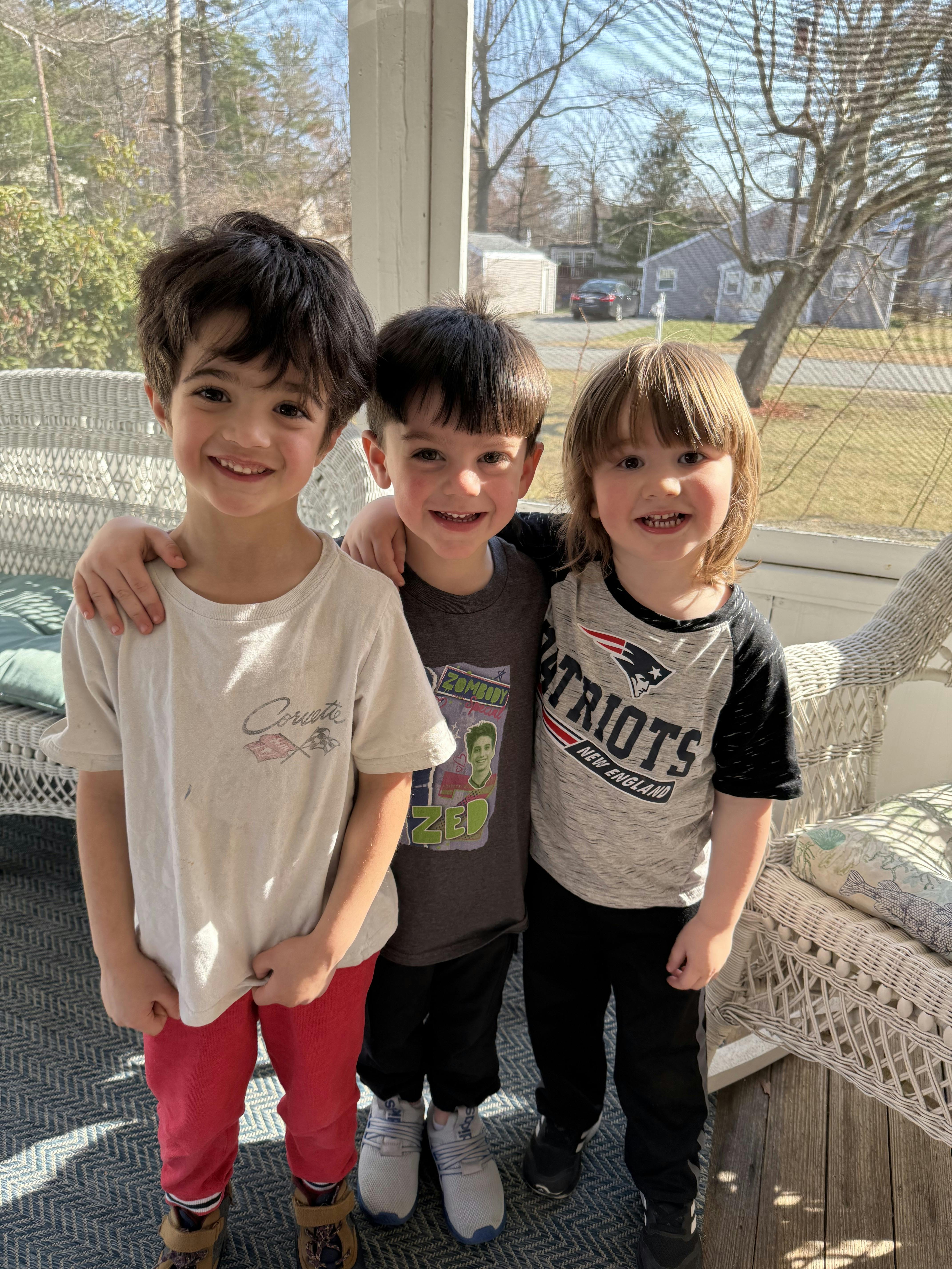 Three children standing together with arms around each other