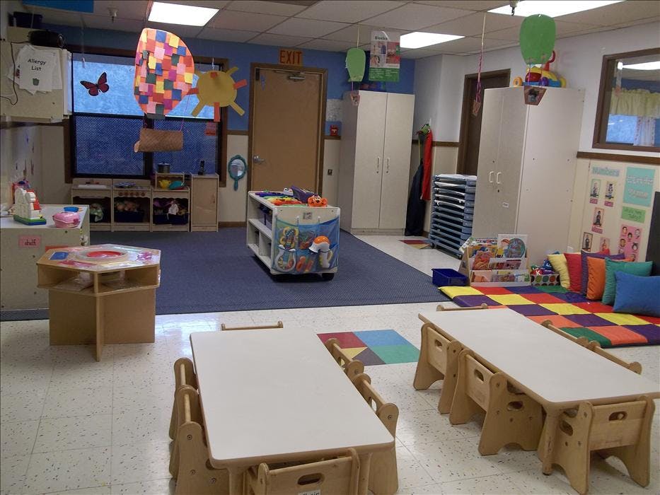 Children's classroom with tables and chairs in the foreground