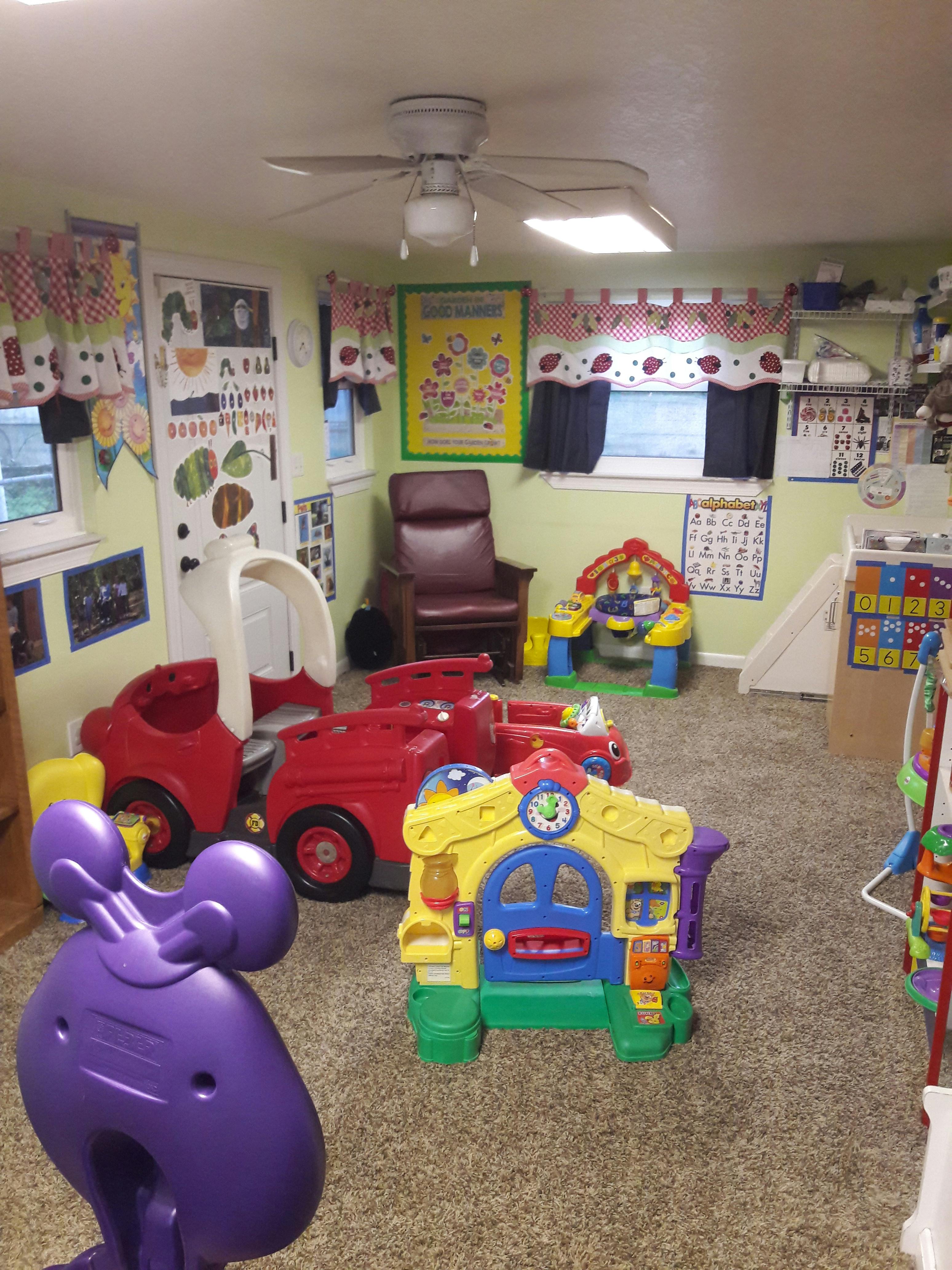 Playroom with various colorful plastic toys and a red armchair