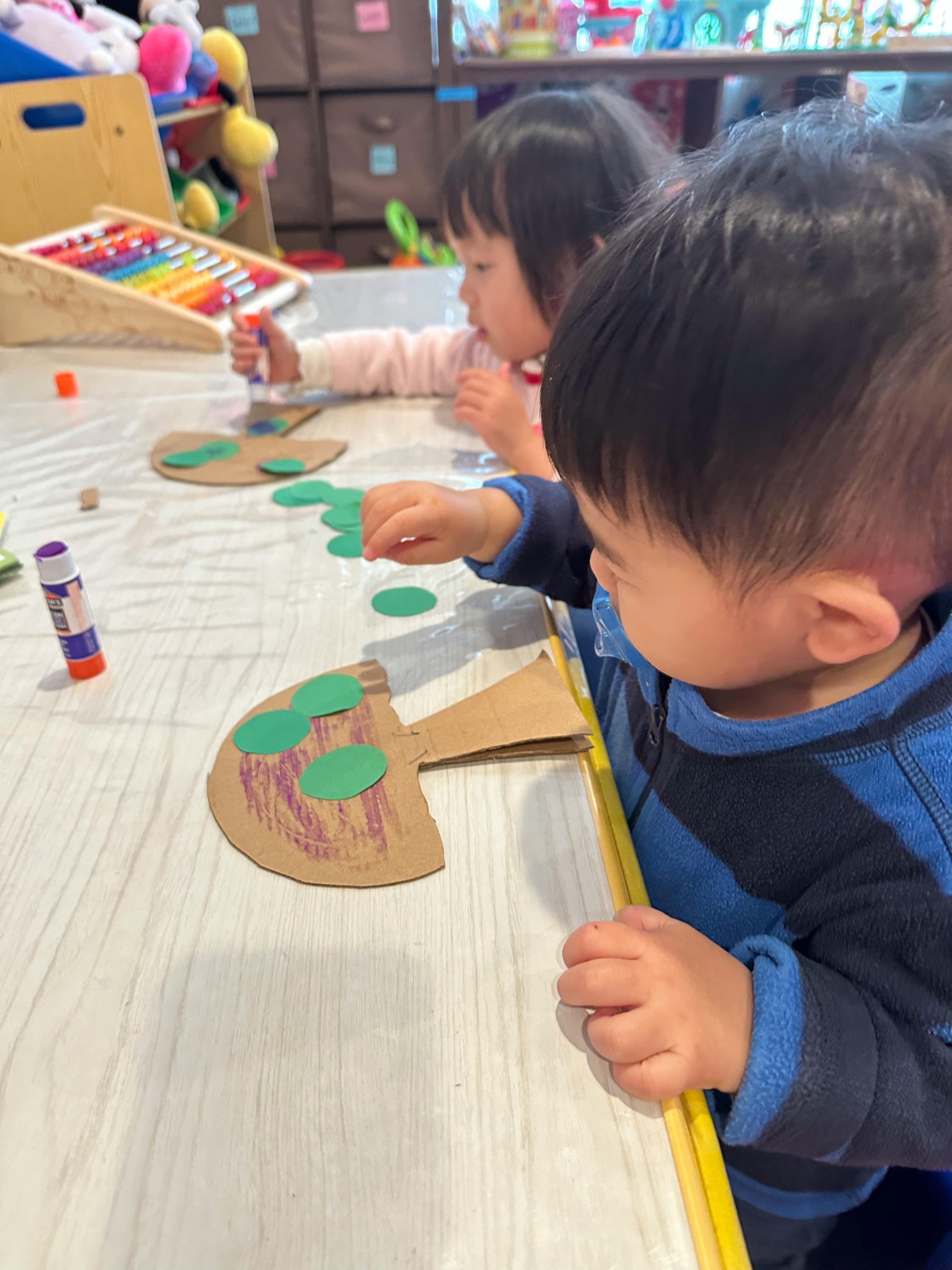 Two children doing crafts at a table