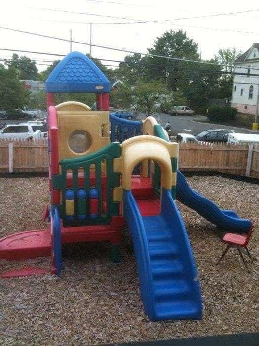 Playground structure with slides and climbing areas on wood chips