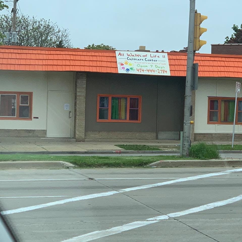 Building with orange roof and sign for "All Walks of Life"