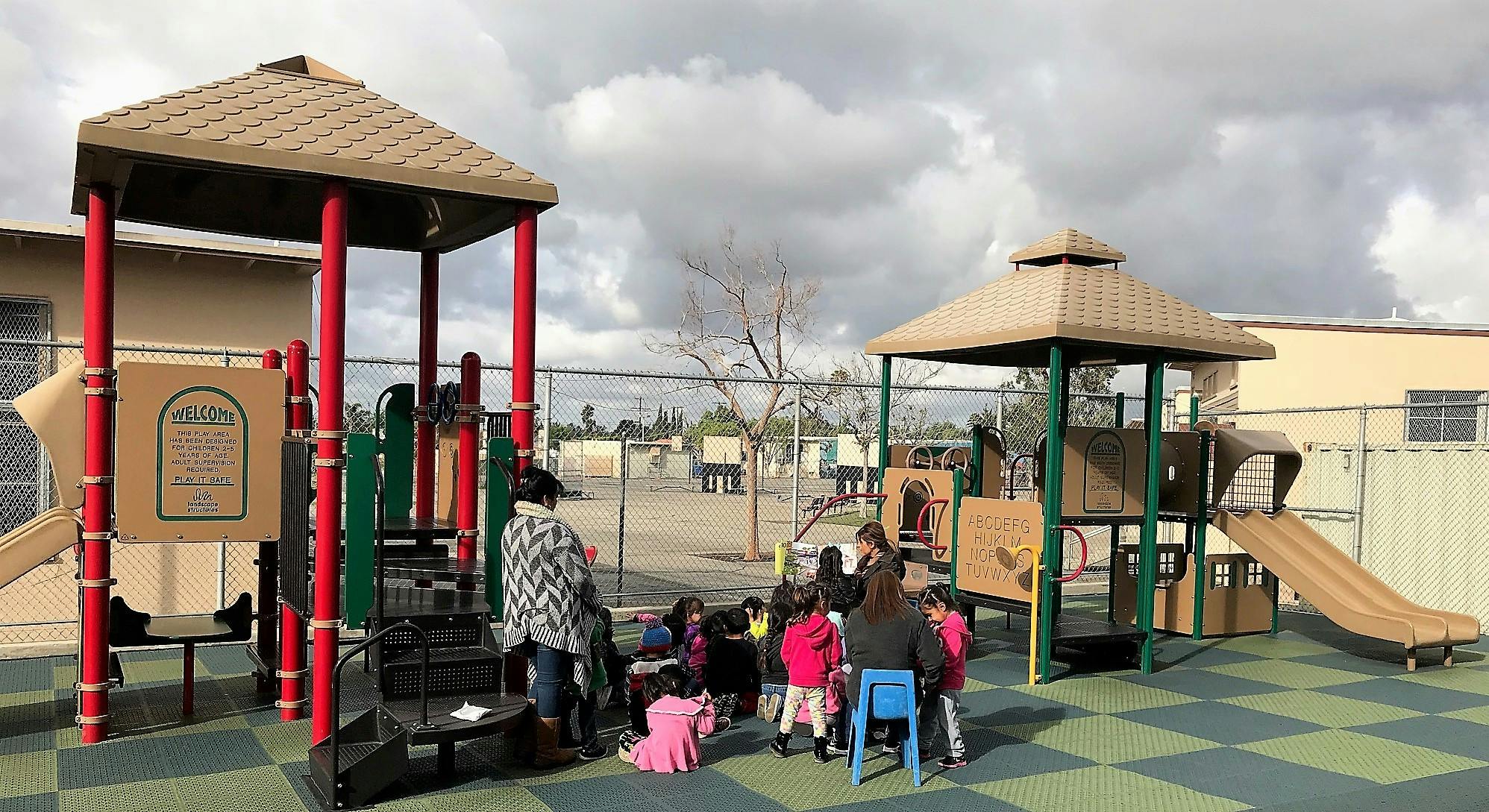 People and children gathered on a playground