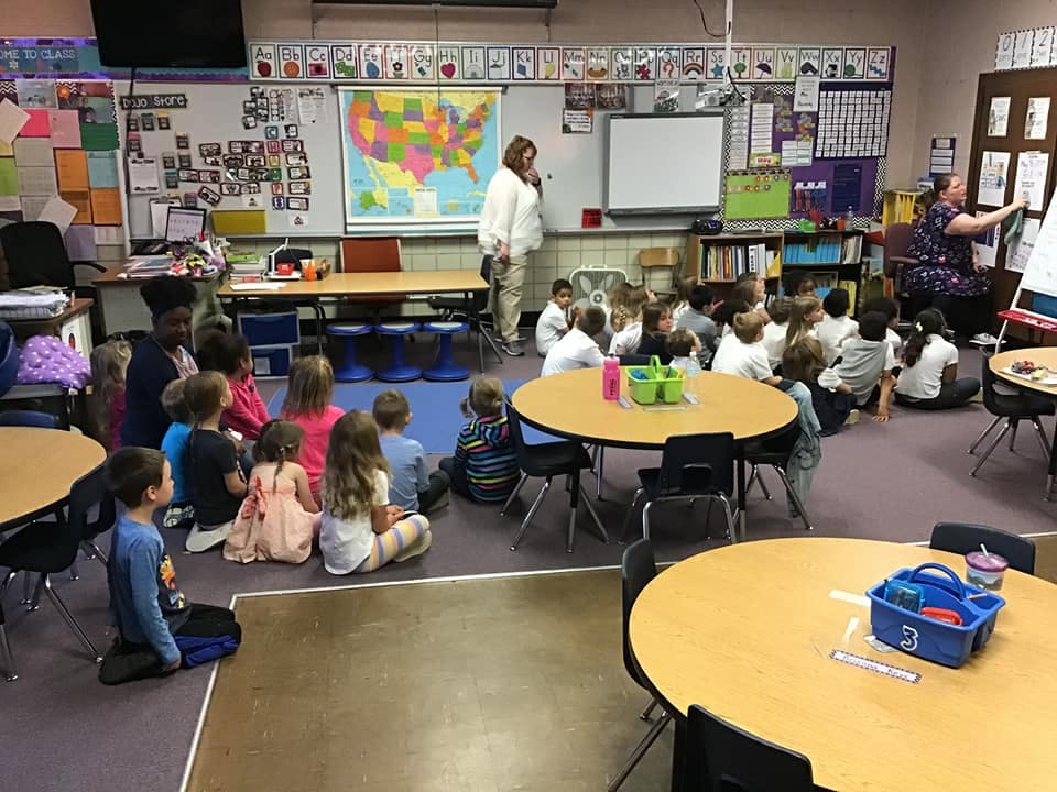 Adults teaching children in a classroom