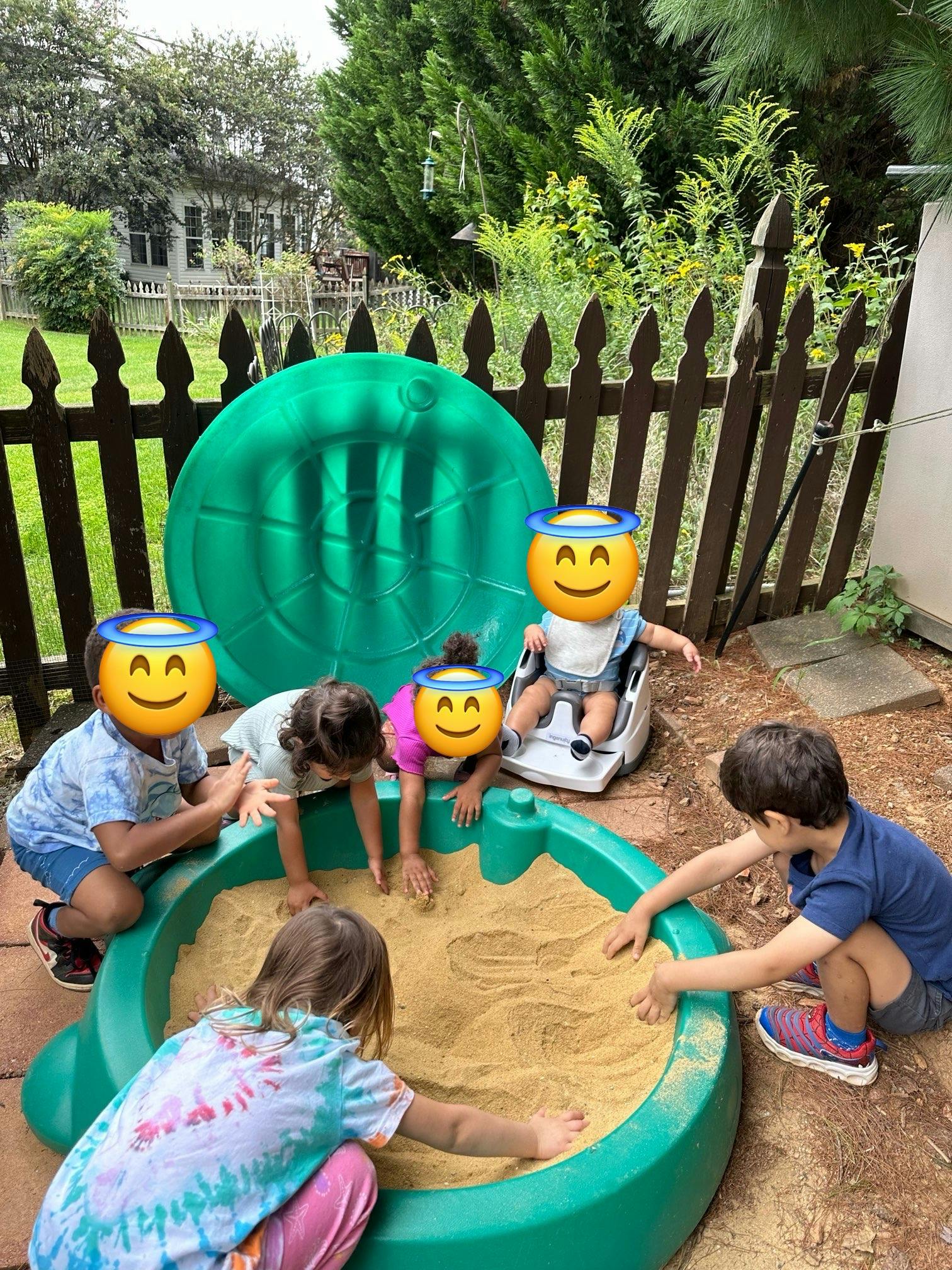 Children playing in a sandbox outdoors