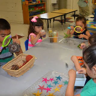 Children at a table with craft supplies