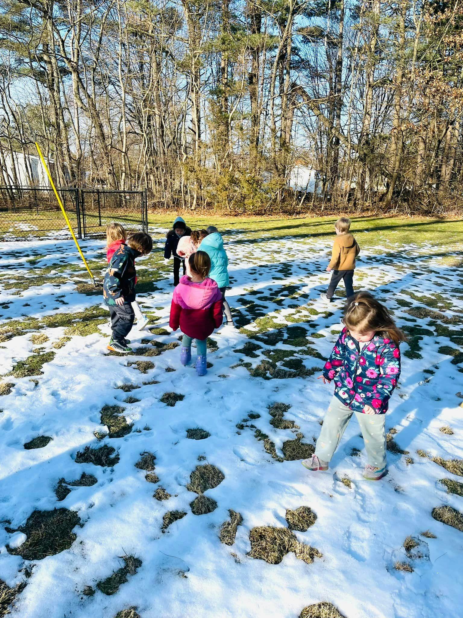 Children playing in a snowy field