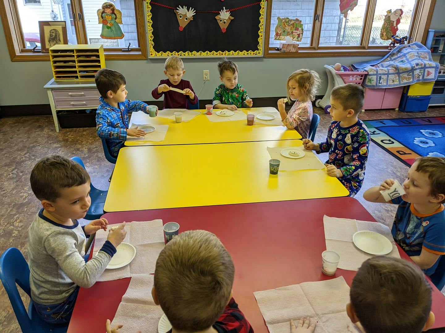 Children sitting at tables in a classroom