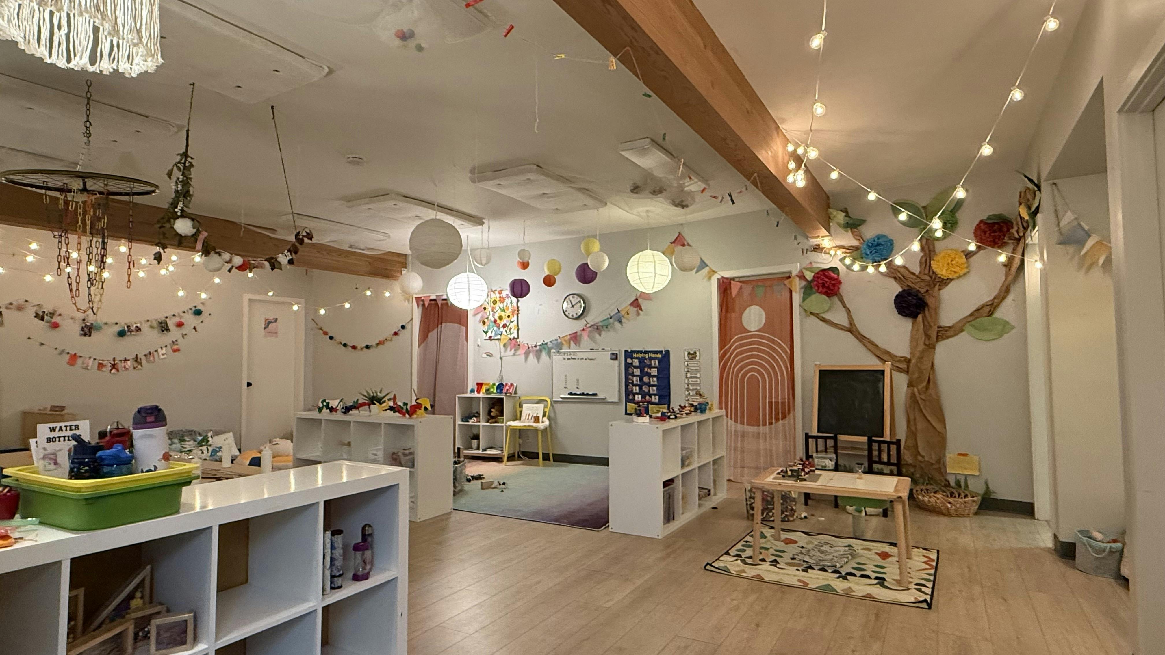Playroom with string lights, decorations, and a tree-like structure