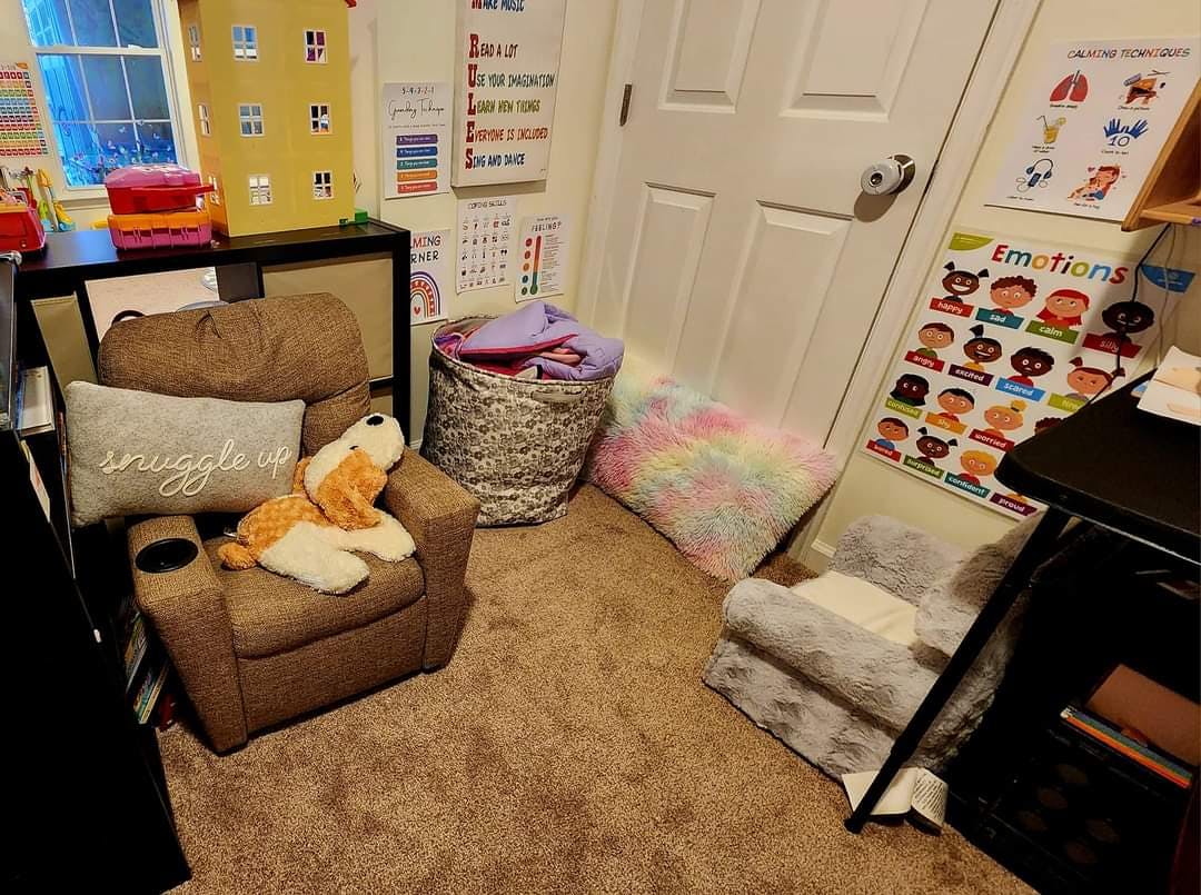 Child's recliner with a stuffed animal and a pillow that says "snuggle"