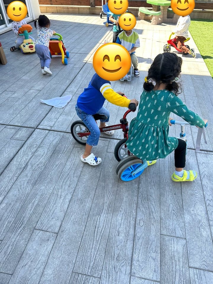 Two children riding balance bikes outdoors