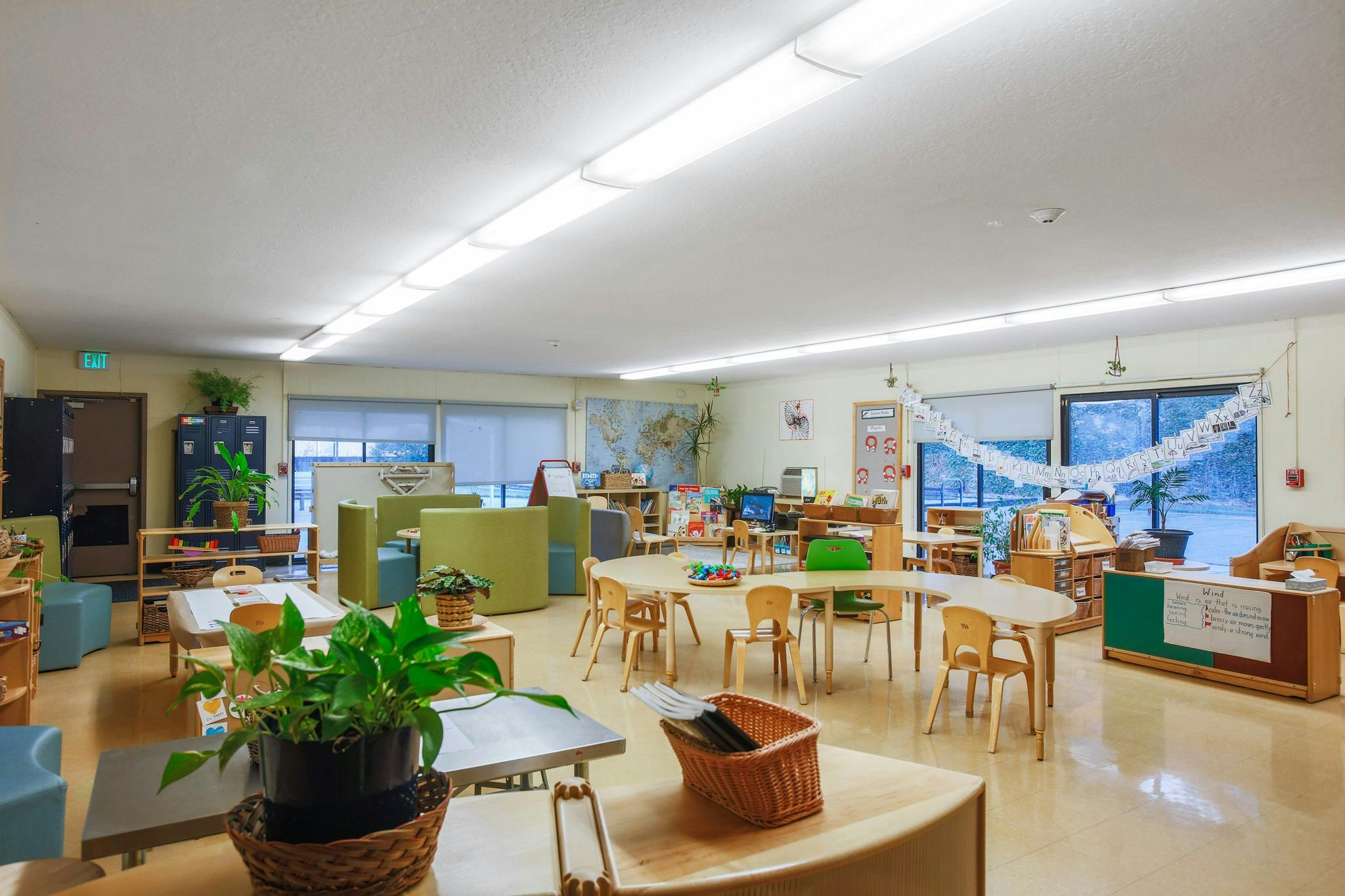 Empty classroom with small tables and chairs