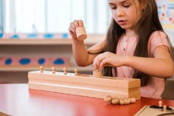 Child playing with wooden blocks on a table