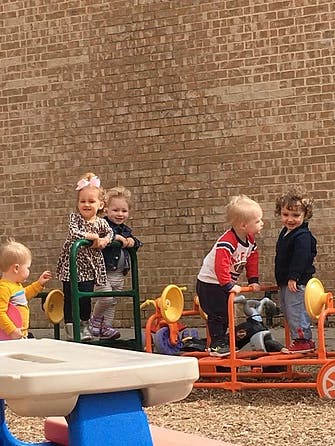 Children playing on outdoor playground equipment