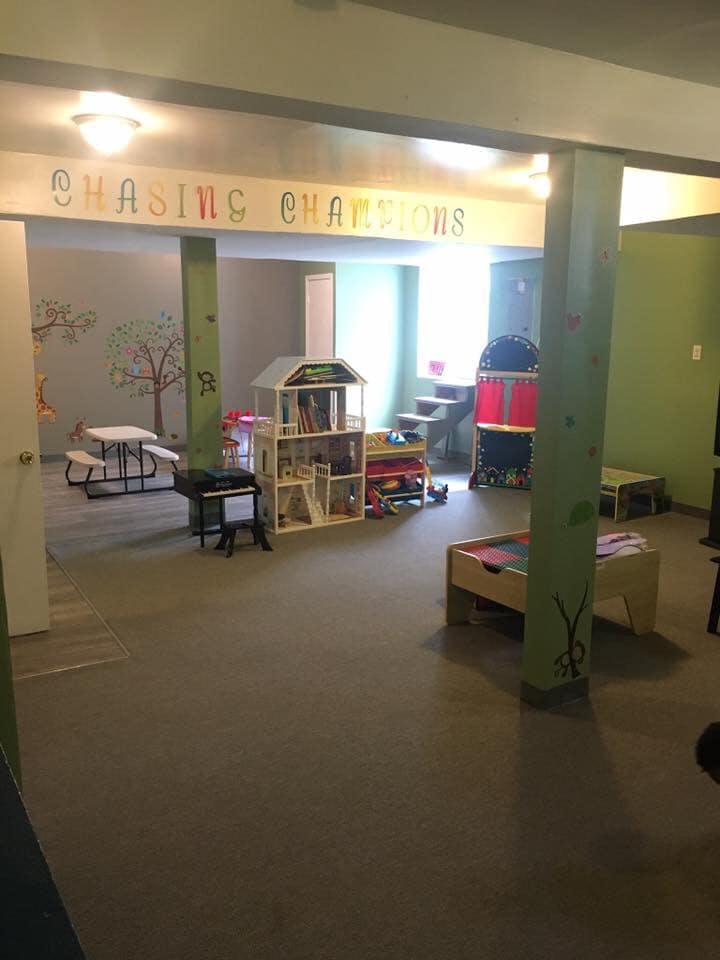 Playroom with toys, dollhouse, and picnic table