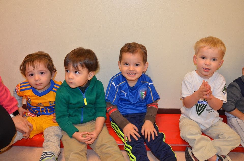 Four children sitting in a row