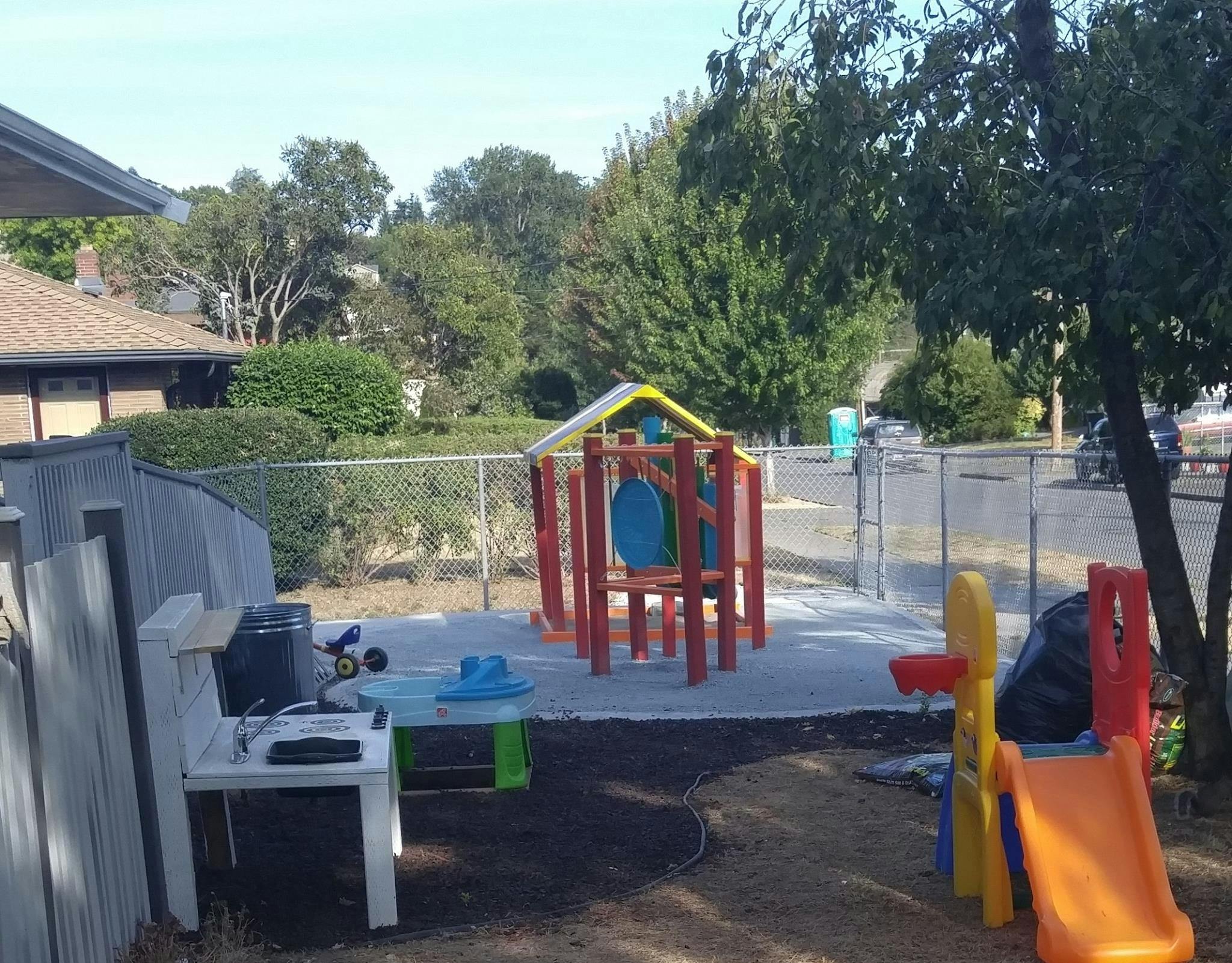 Playground with a small climbing structure and a slide
