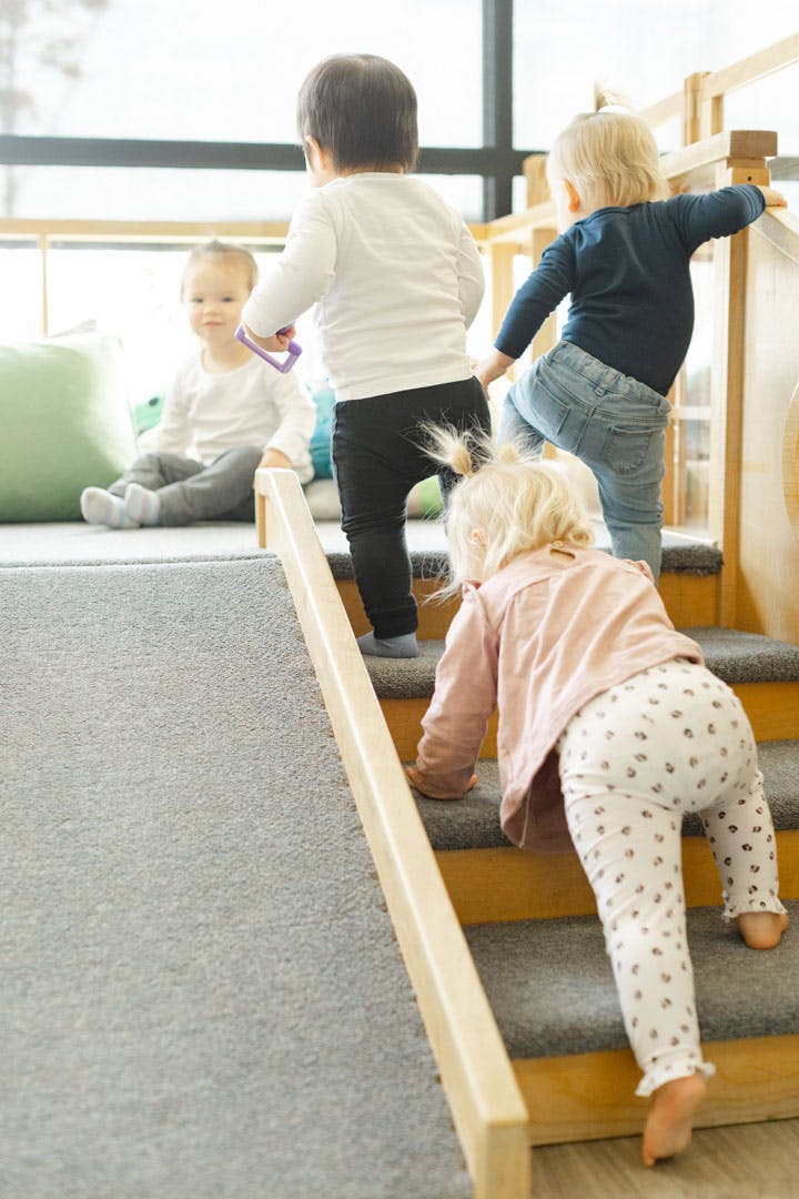 Children climbing stairs and sitting on a platform