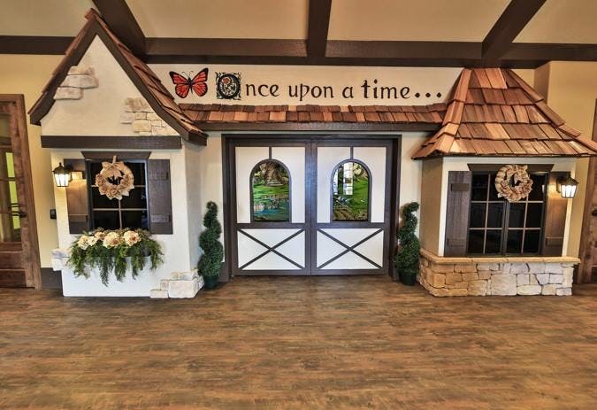 Miniature house facade with "Once upon a time..." text above
