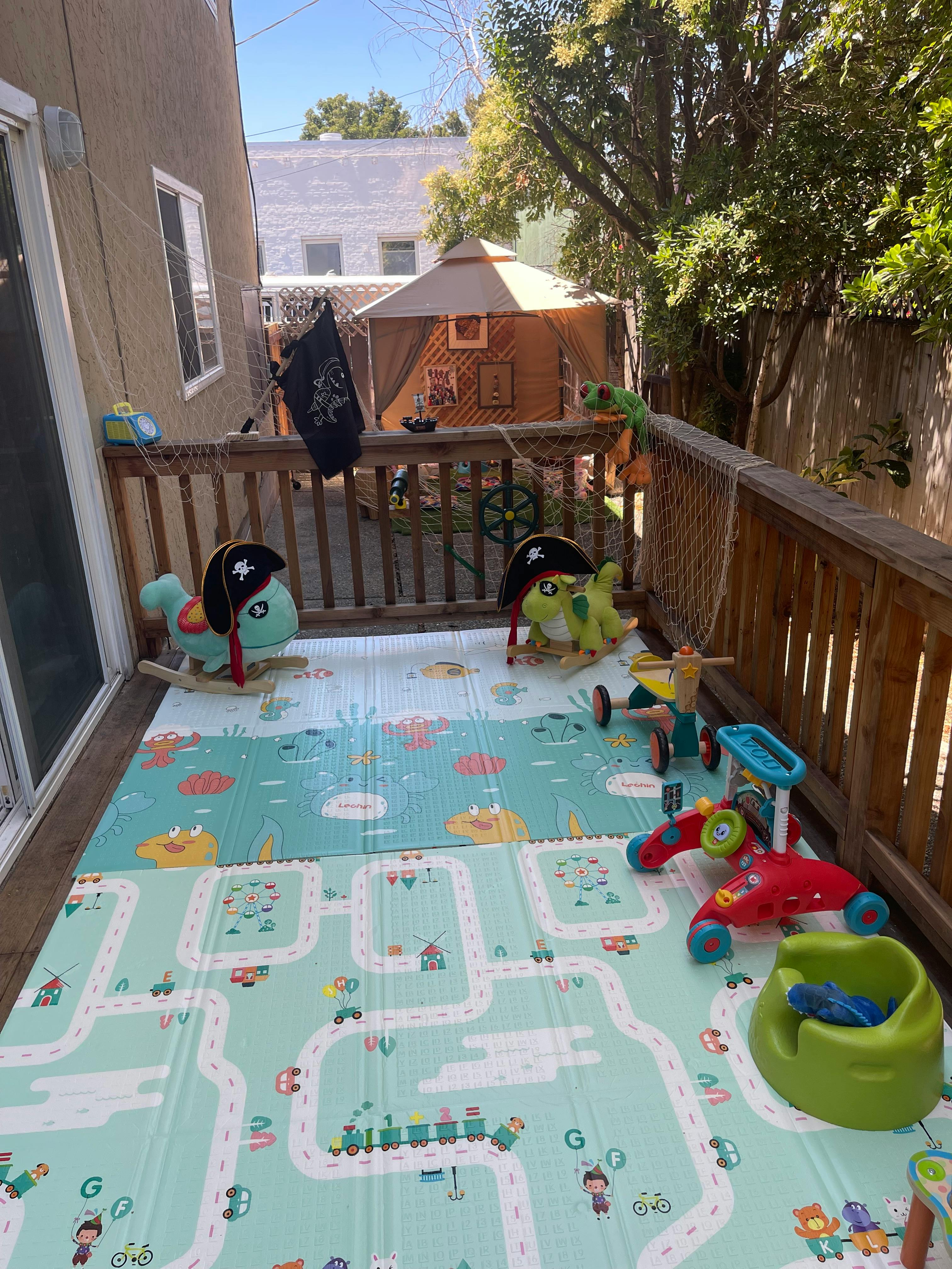 Outdoor patio with play mats and children's toys