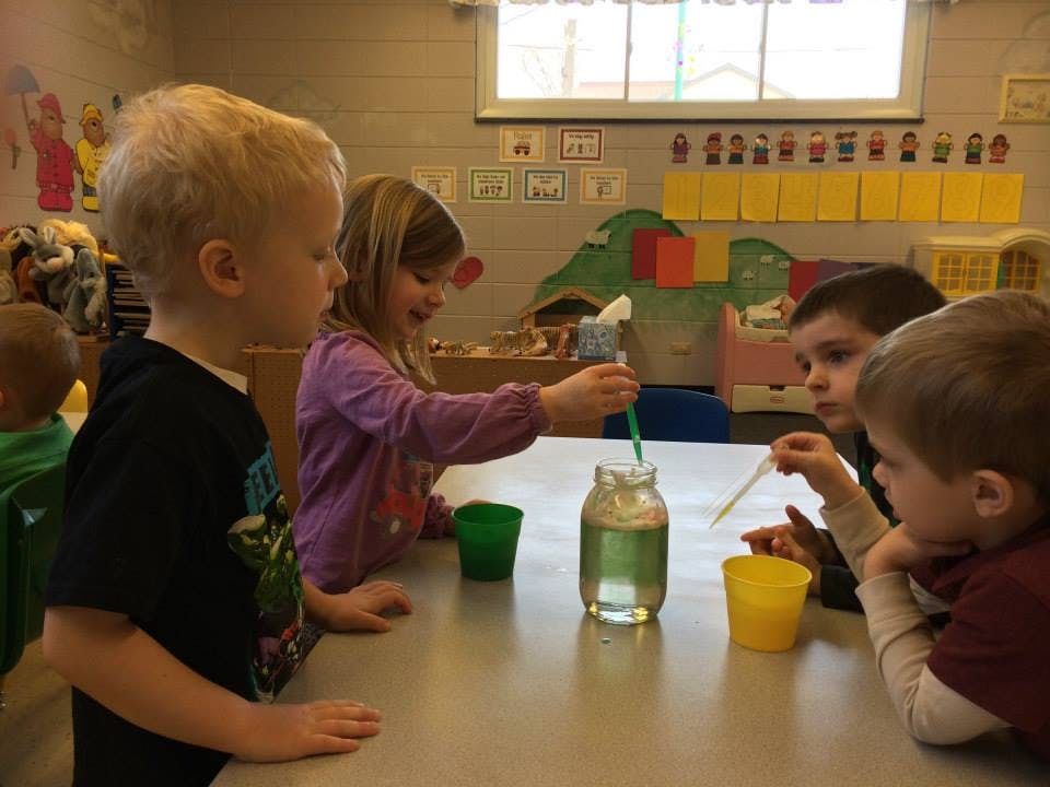Children doing a science experiment in a classroom