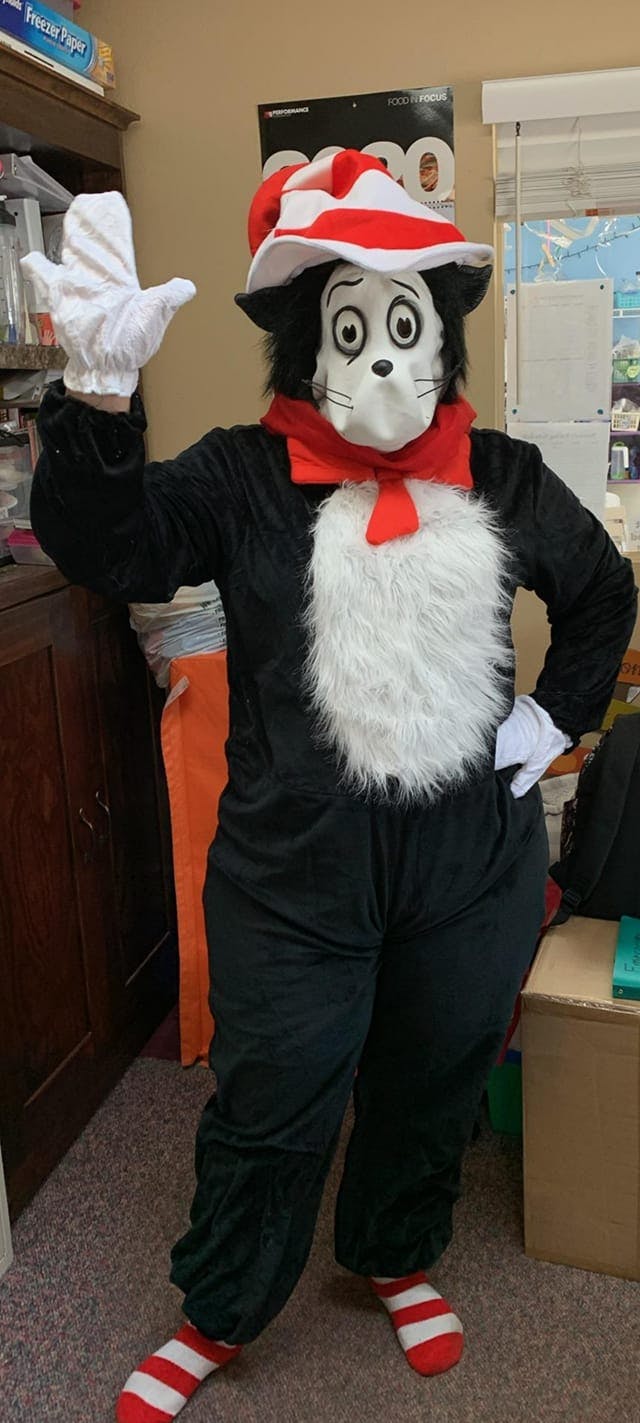 Person in a Cat in the Hat costume with one arm raised