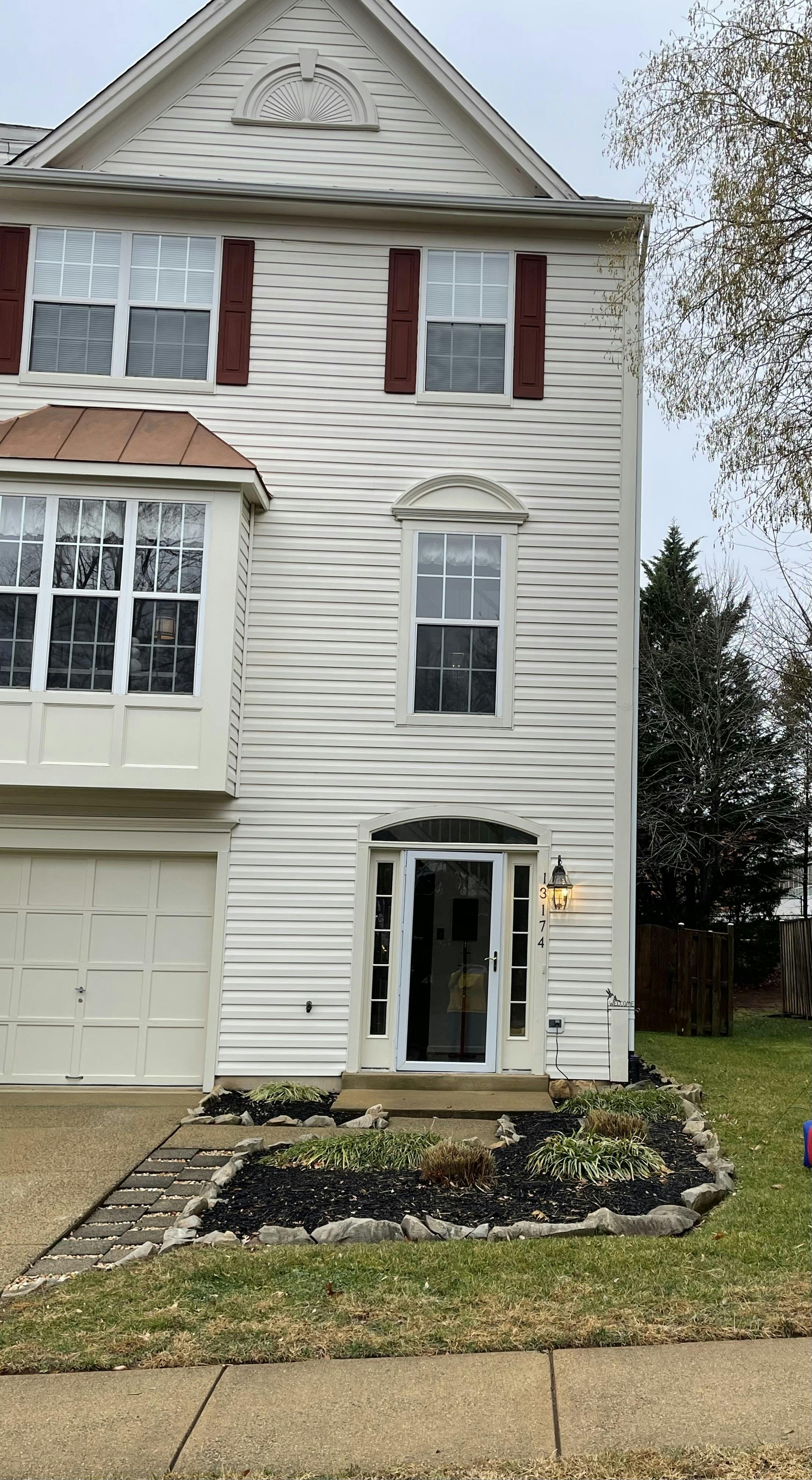 Exterior of a three-story house with a front door numbered 3174