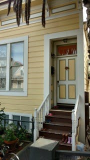 Front door and steps of a yellow house