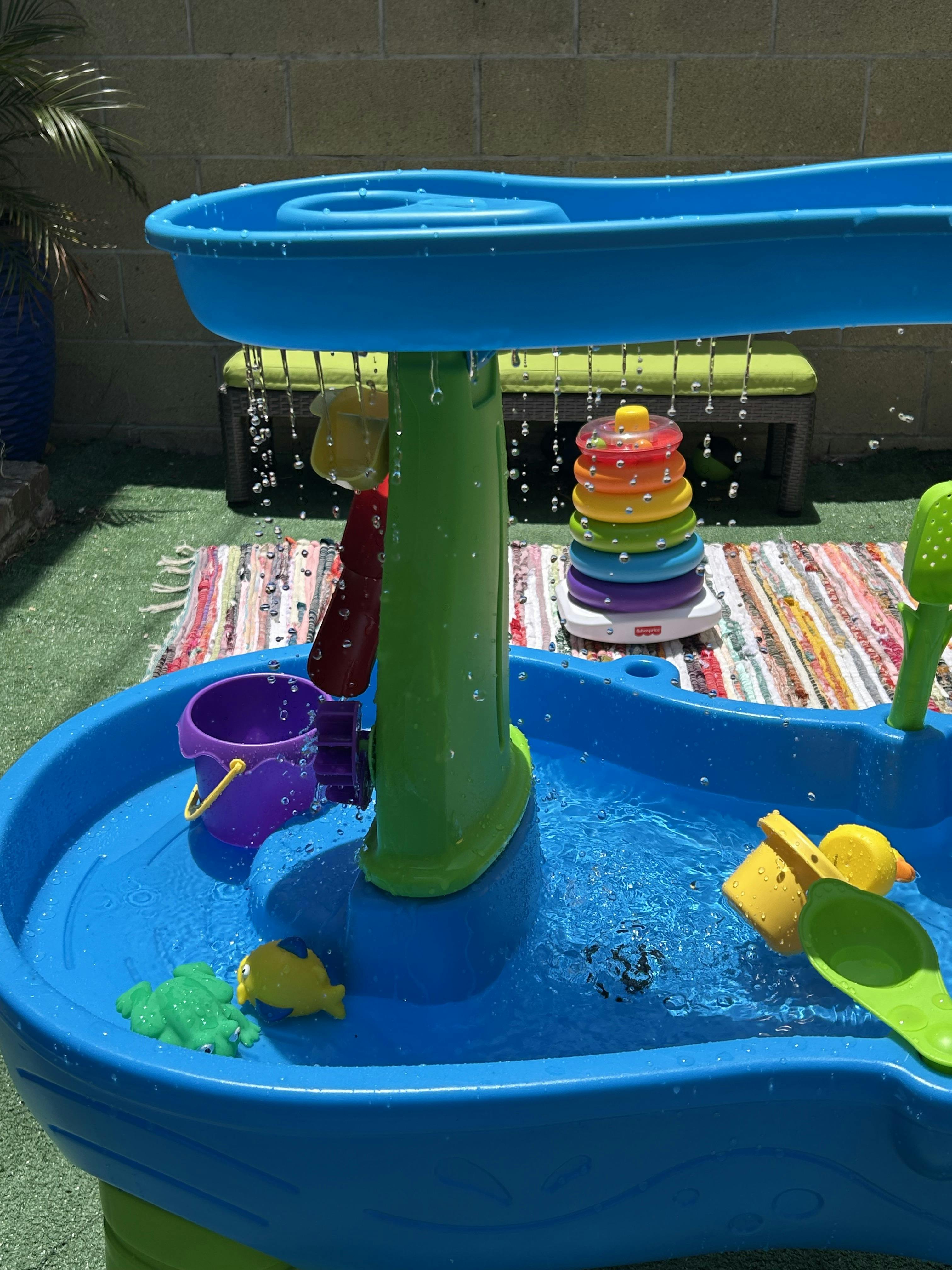 Plastic water table with cascading water and floating toys