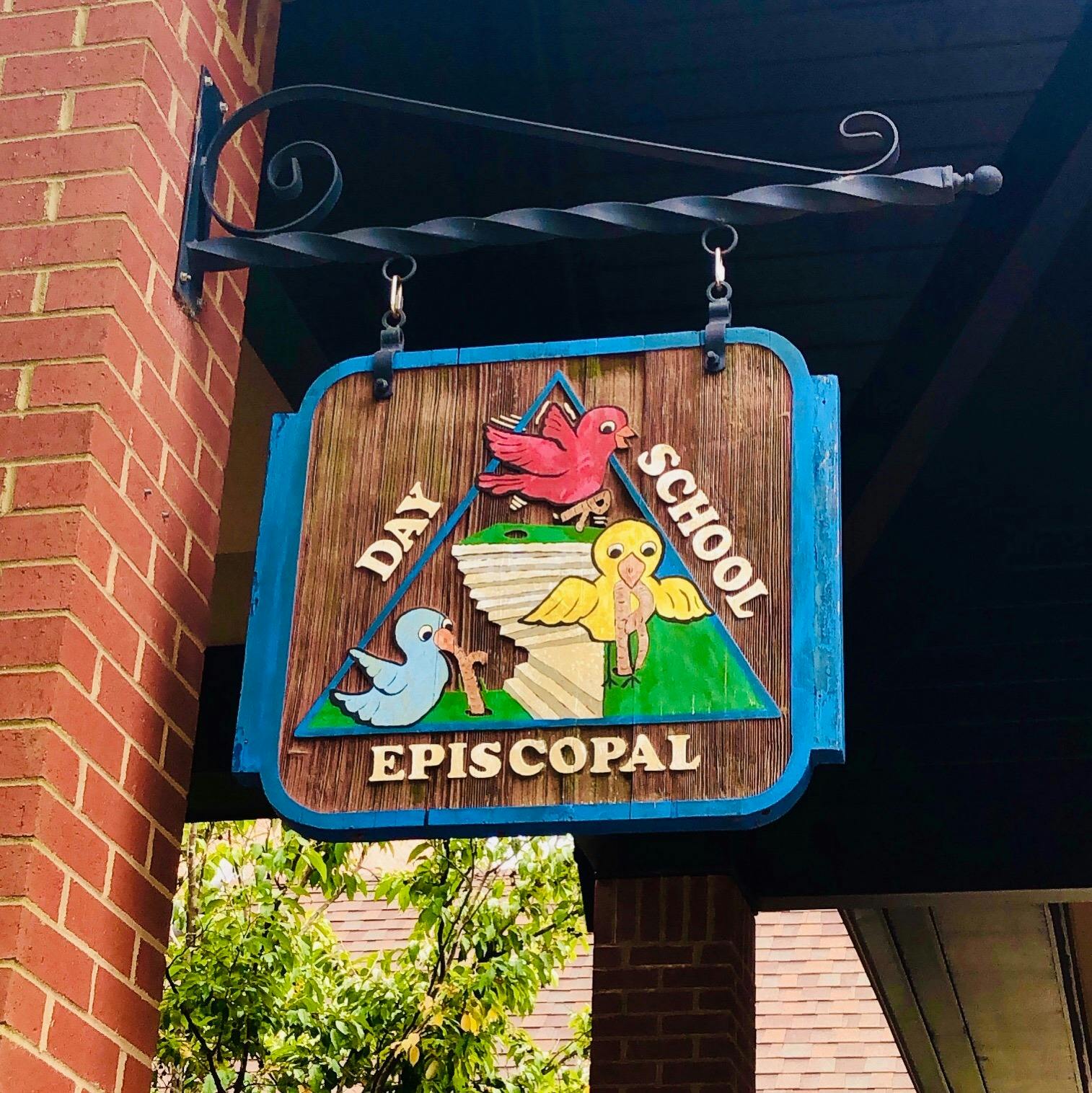 Hanging sign for Day School Episcopal with bird illustrations