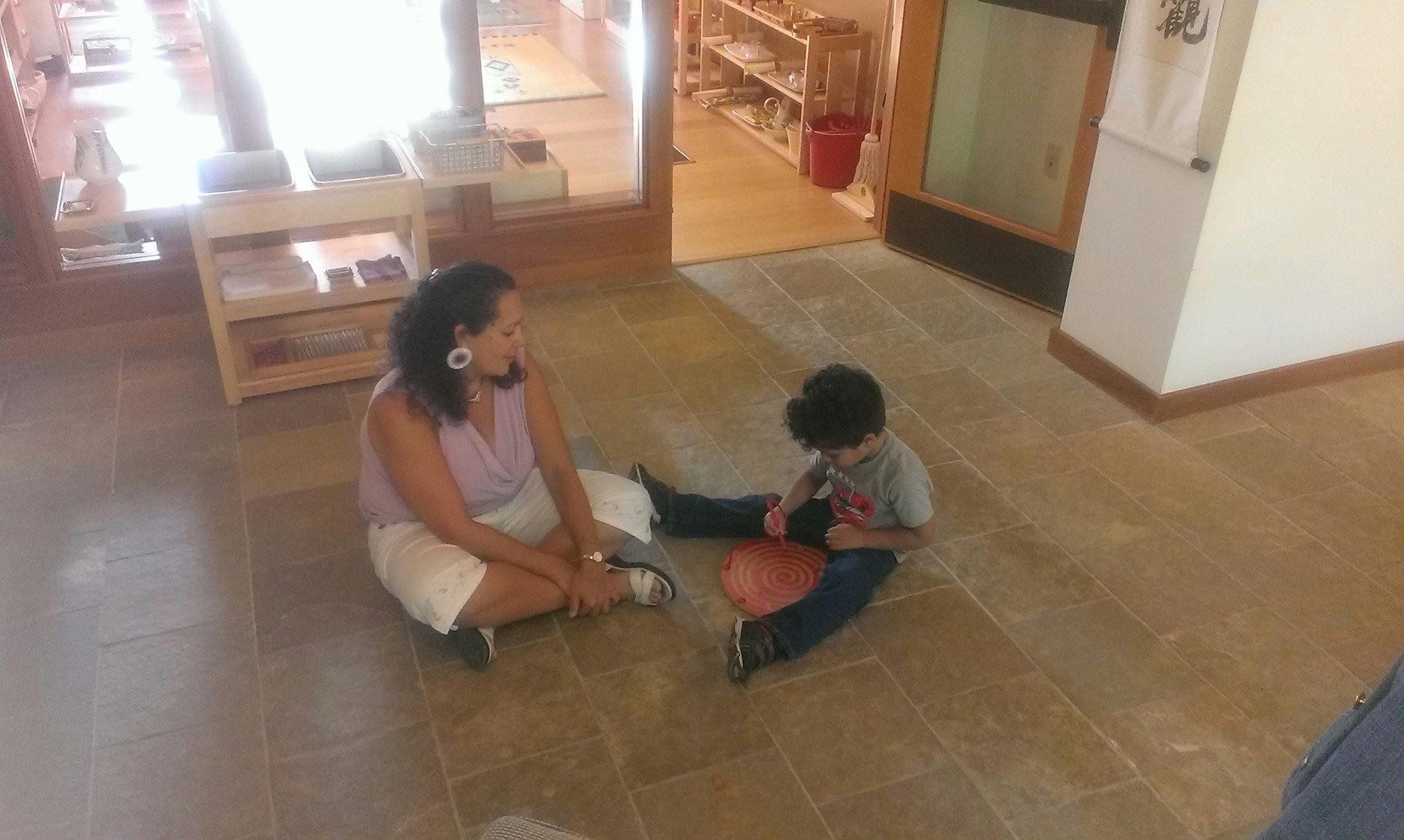 Person and child sitting on floor