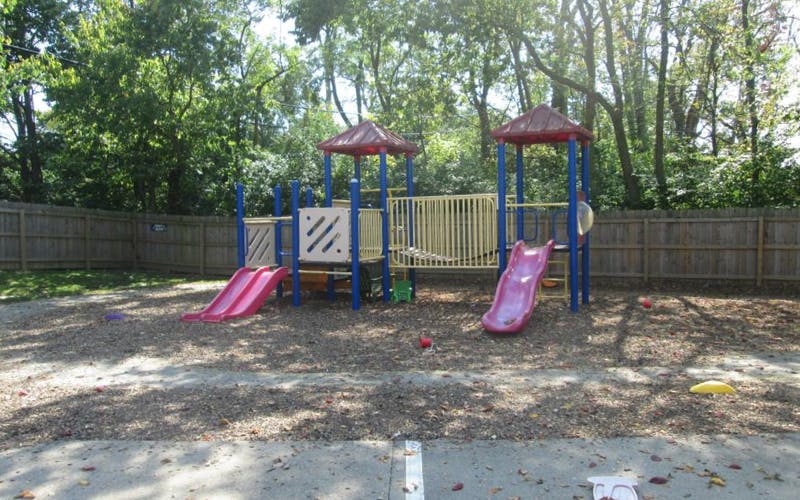 Playground with two pink slides and red roofs on a sunny day