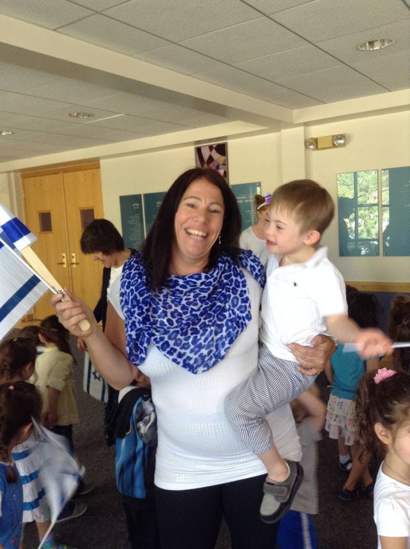 Person holding a child and a flag