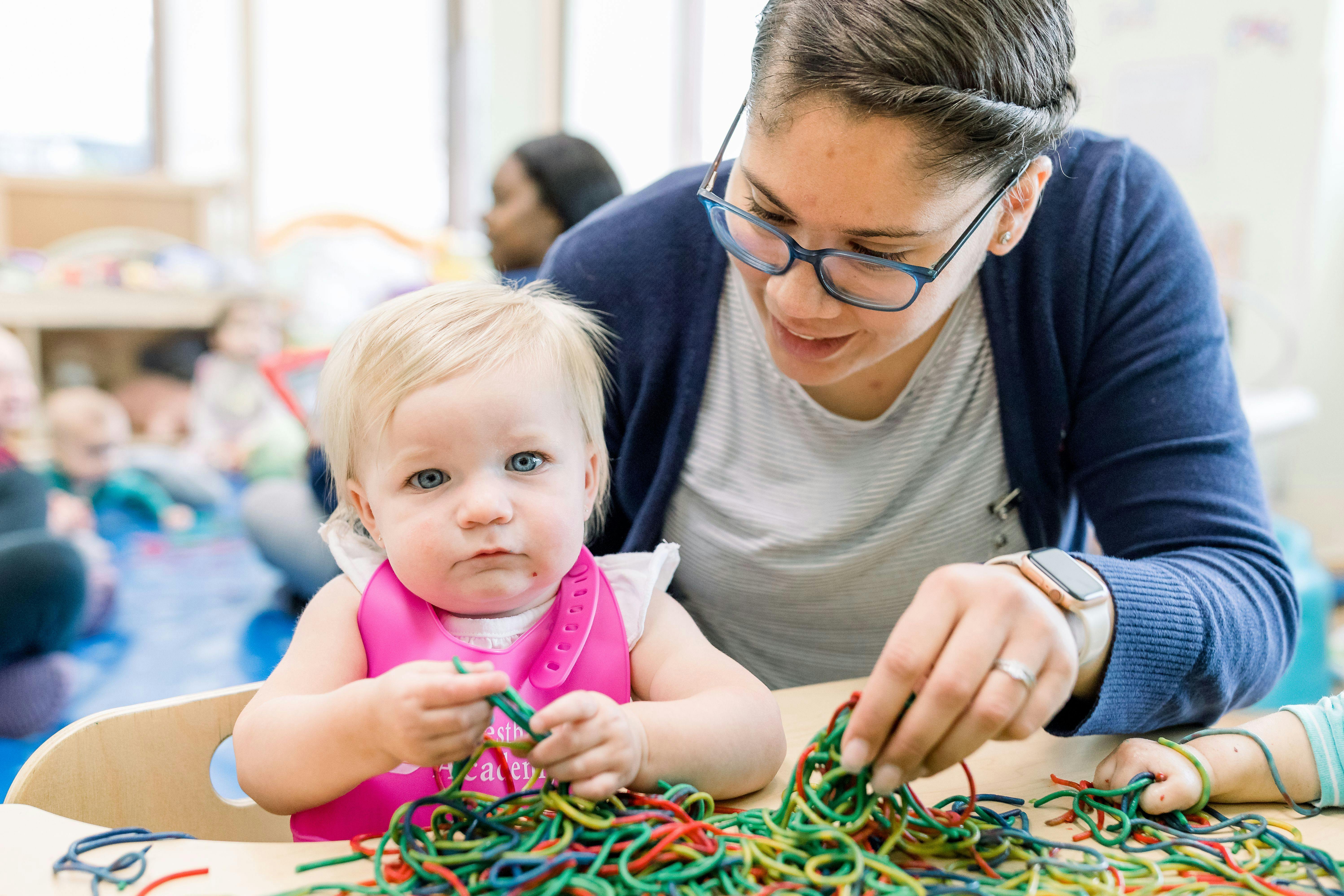 Adult and child playing with colorful strings