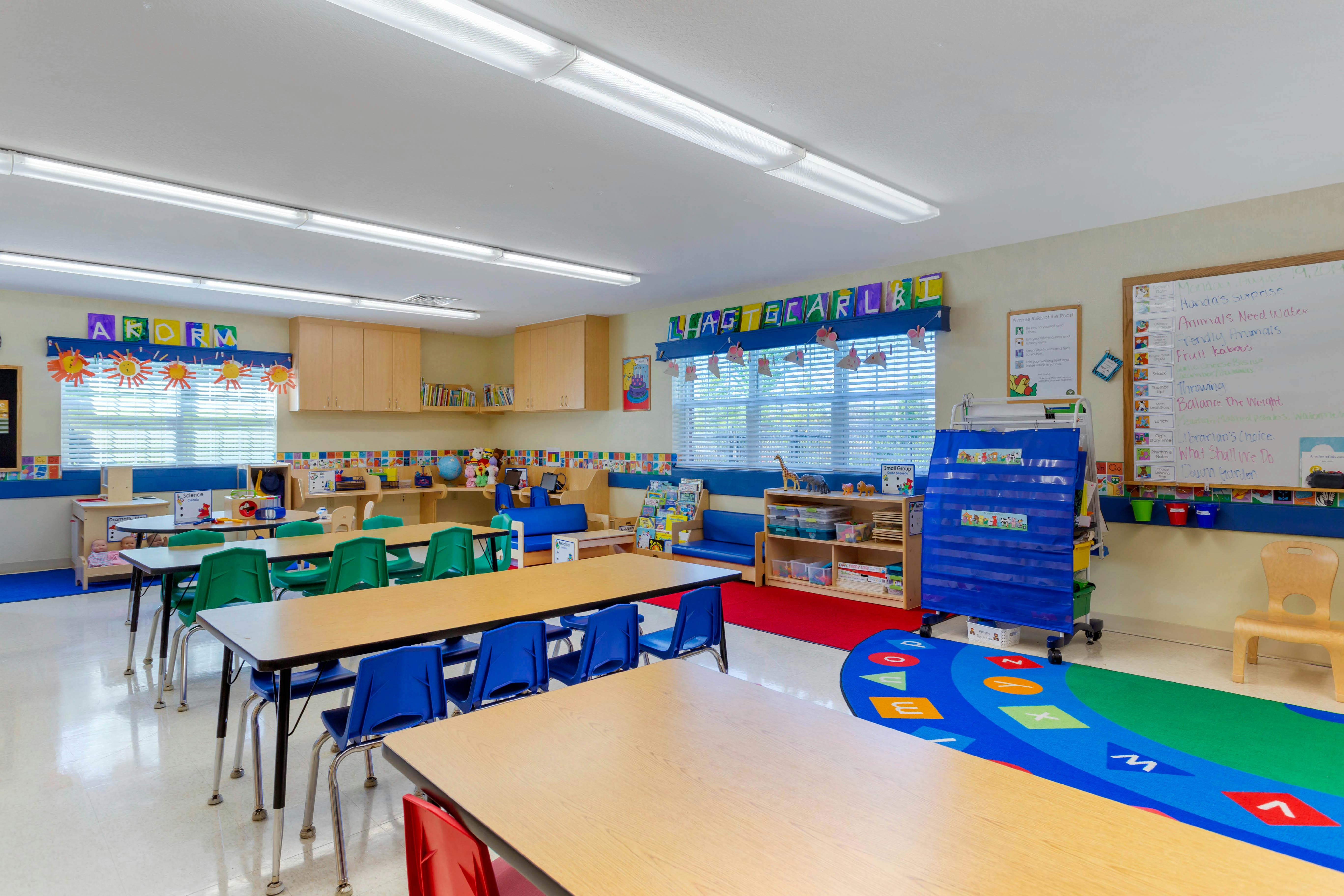 A classroom with tables, chairs, and colorful decorations