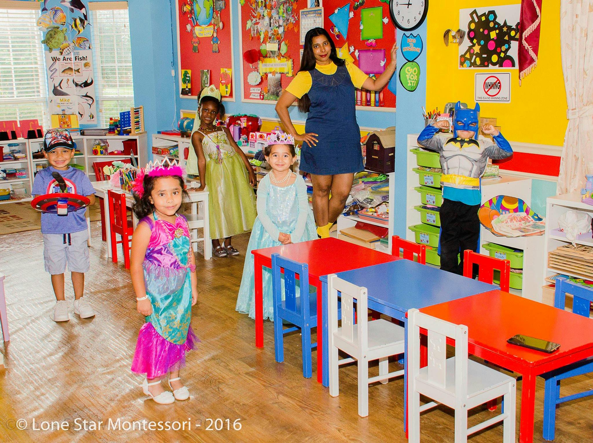 Adult and children in costumes in a classroom