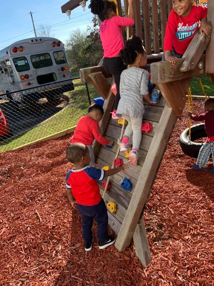 Children playing on a climbing structure at a playground